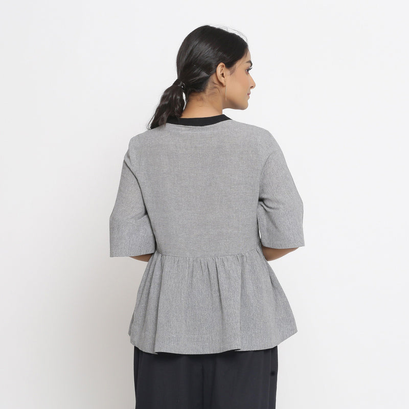 Back View of a Model wearing Solid Grey Yarn Dyed Cotton Peplum Top