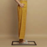 Right View of a Model wearing Mustard Paneled Striped Handwoven Pant