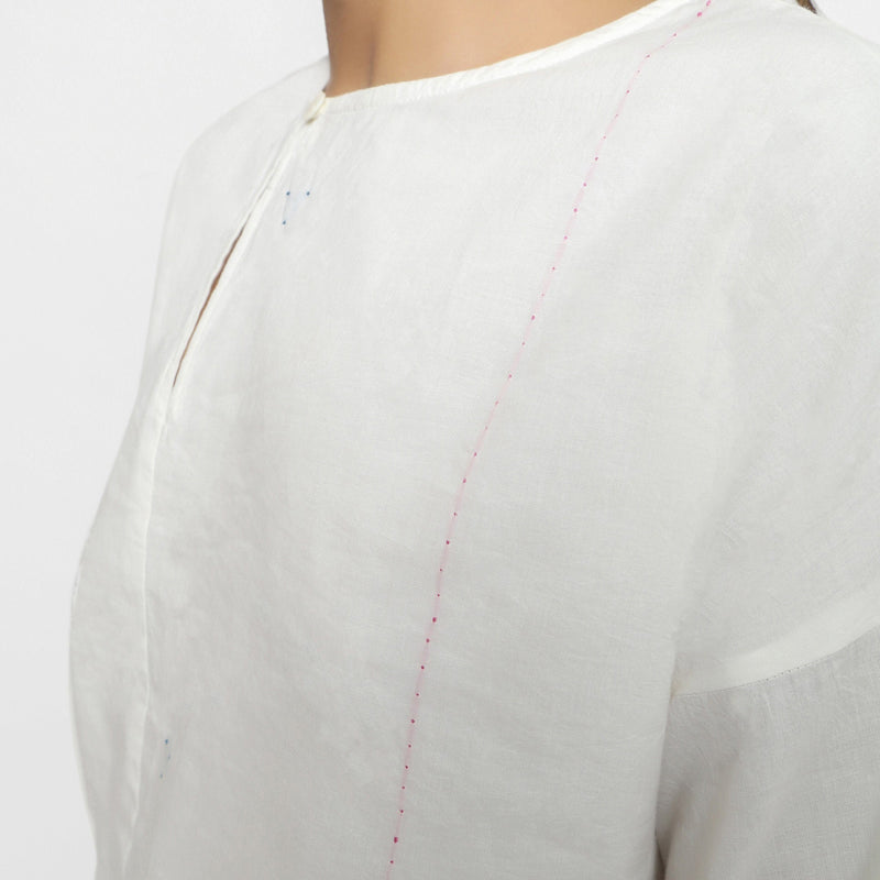 Left Detail of a Model wearing Hand Embroidered Organic Cotton Paneled Top