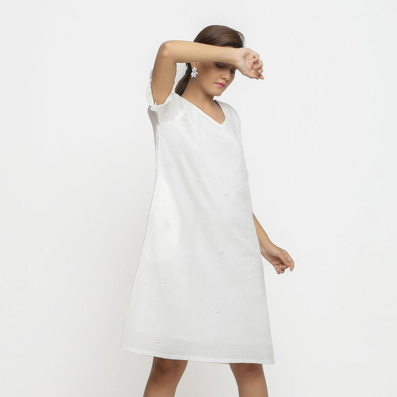 Right View of a Model wearing White Hand Embroidered Organic Cotton Knee Length Shift Dress