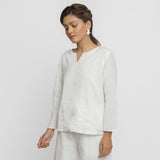 Left View of a Model wearing White Embroidered Organic Cotton Split Neck Top