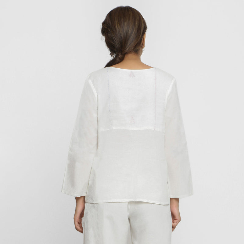 Back View of a Model wearing White Embroidered Organic Cotton Split Neck Top