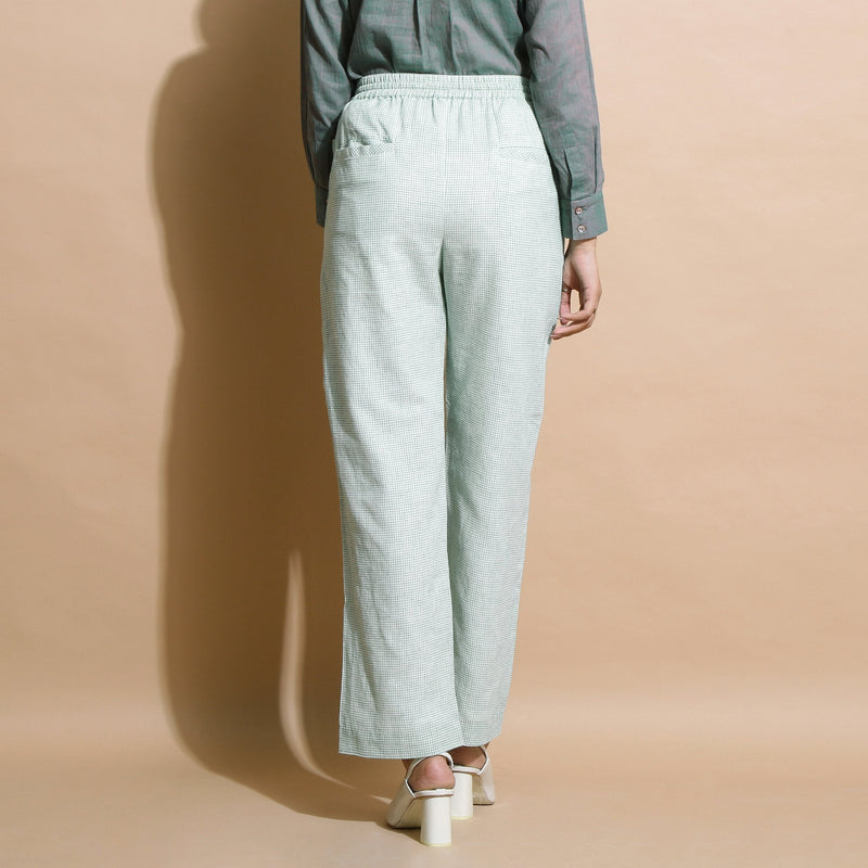 Back View of a Model wearing Light Green Checkered Cotton Muslin Elasticated Mid-Rise Pant
