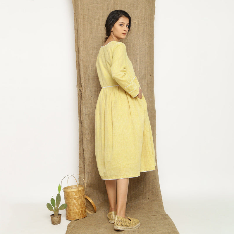 Back View of a Model wearing Handspun Light Yellow Gathered Dress