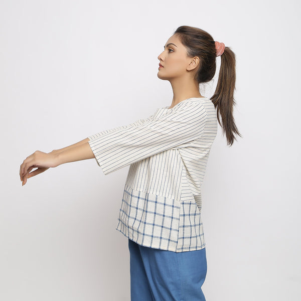 Left View of a Model wearing White and Blue Vegetable Dyed Handspun Cotton Paneled Top