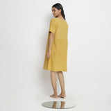 Back View of a Model wearing Lemon Yellow Vegetable Dyed Handspun Cotton Knee Length Yoked Dress