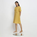 Left View of a Model wearing Lemon Yellow Vegetable Dyed Handspun Cotton Knee Length Yoked Dress