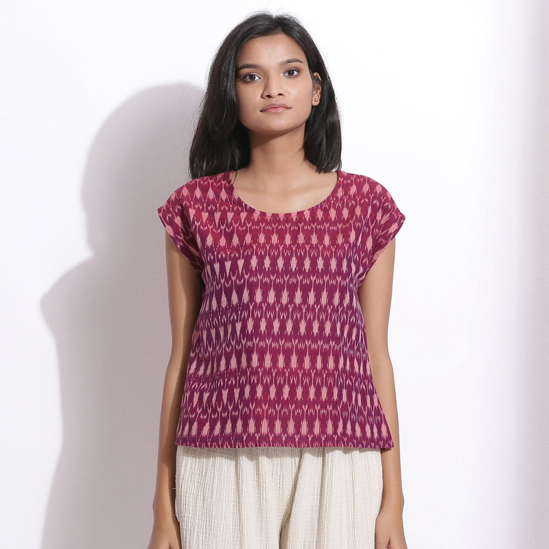 Front View of a Model wearing Berry Wine Handwoven Cotton Ikat Round Neck Cap Sleeve Top