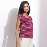 Rigth View of a Model wearing Berry Wine Handwoven Cotton Ikat Round Neck Cap Sleeve Top