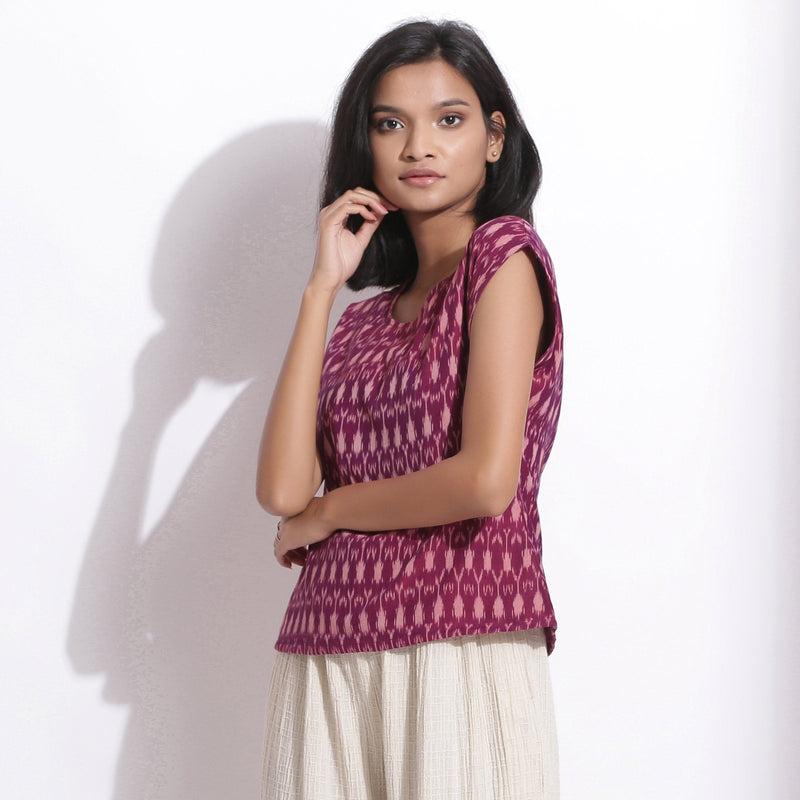 Left View of a Model wearing Berry Wine Handwoven Cotton Ikat Round Neck Cap Sleeve Top