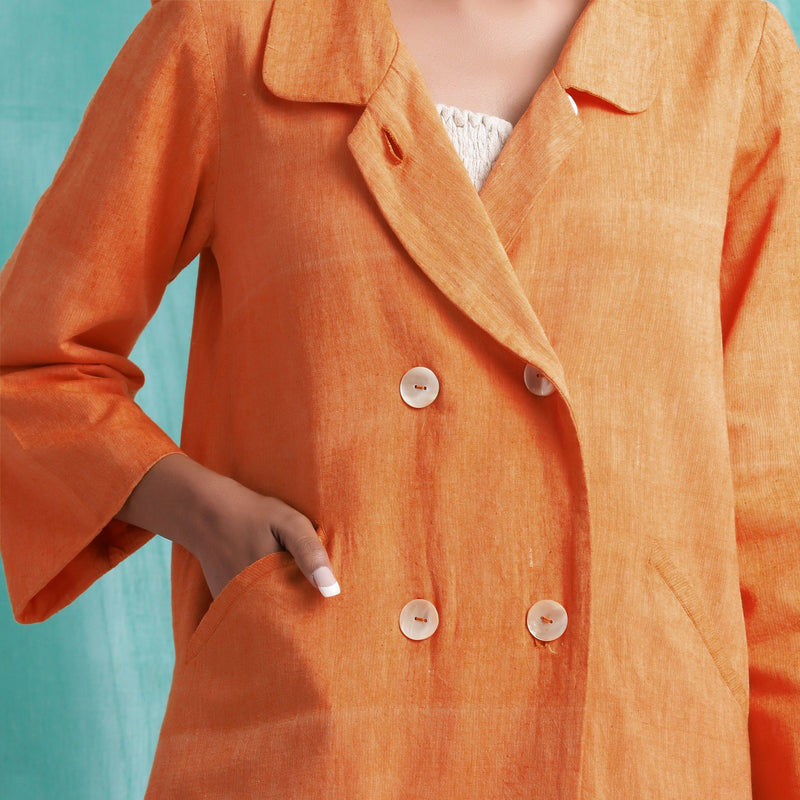 Front Detail of a Model wearing Handwoven Orange Welt Pocket Coat