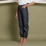 Left View of a Model wearing Indigo Cotton Denim Elasticated Mid-Rise Jogger Pant