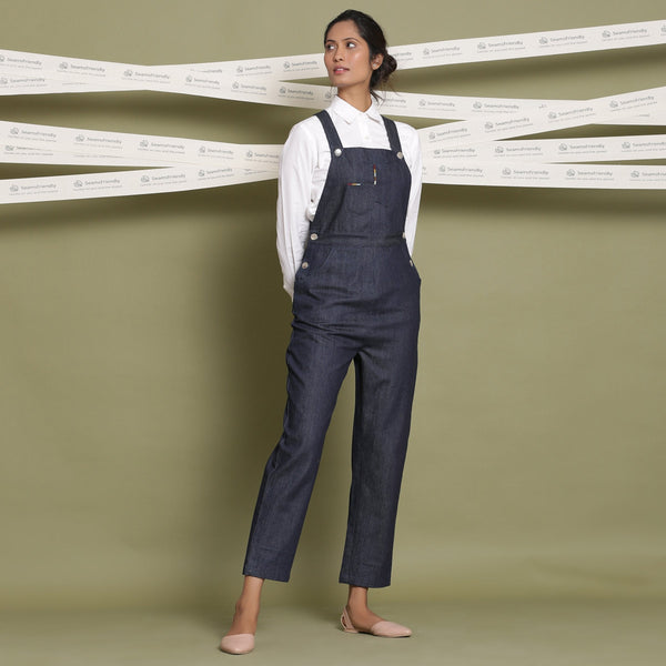 Right View of a Model wearing Indigo 100% Cotton Denim Strap Sleeve Dungaree