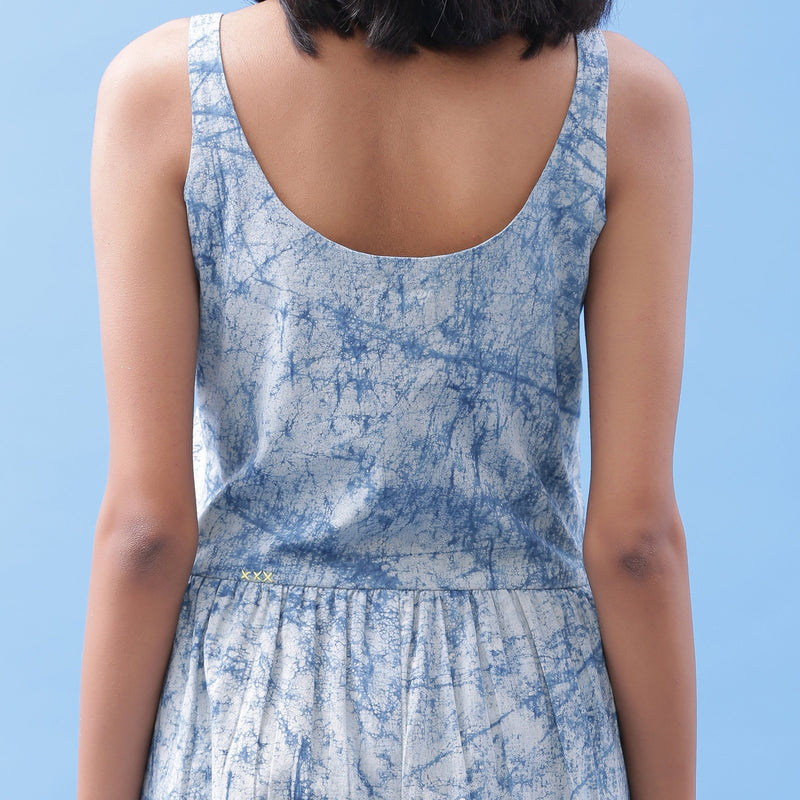 Back Detail of a Model wearing Indigo Dabu Printed Button-Down Jumpsuit