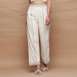 Front View of a Model wearing Ecru Jute Laced Cotton Muslin Mid-Rise Elasticated Pant