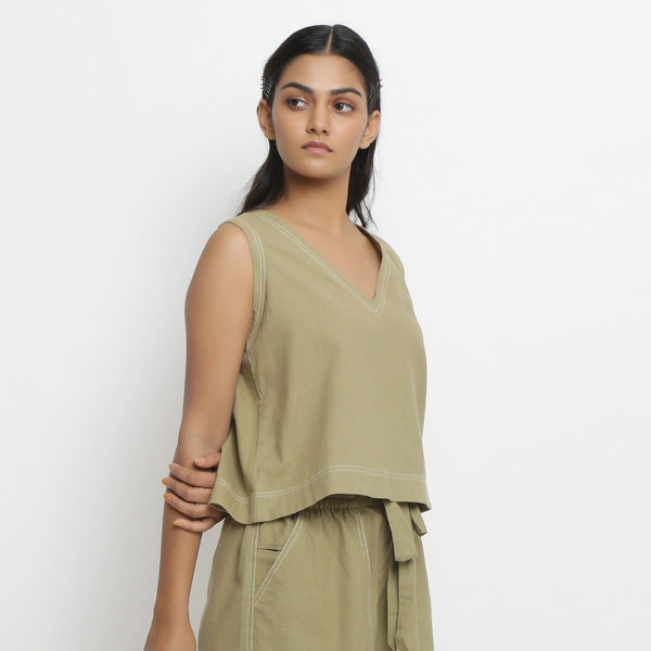 Right View of a Model wearing Khaki Green Vegetable Dyed Handspun Cotton Sleeveless Crop Top