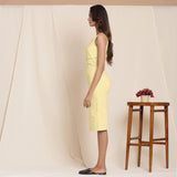 Left View of a Model wearing Lemon Yellow Knee Length Cotton Sheath Dress