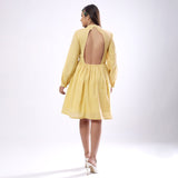 Back View of a Model wearing Light Yellow Backless Gathered Dress