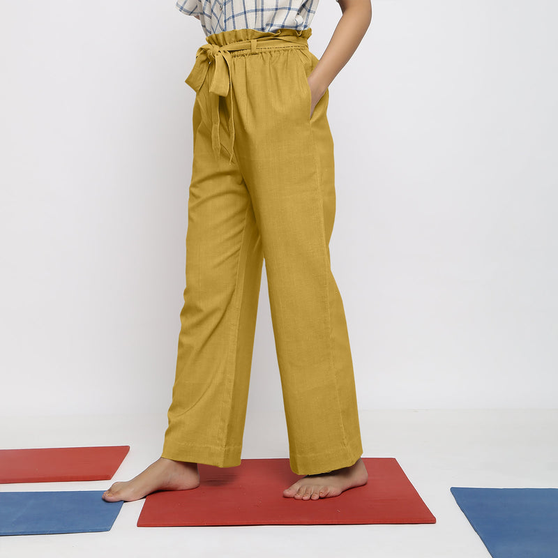 Left View of a Model wearing Light Yellow Vegetable Dyed Handspun Cotton Elasticated Wide Legged Paperbag Pant