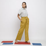 Right View of a Model wearing Light Yellow Vegetable Dyed Handspun Cotton Elasticated Wide Legged Paperbag Pant