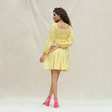 Back View of a Model wearing Light Yellow Handspun Cotton Bohemian Gathered Short Dress