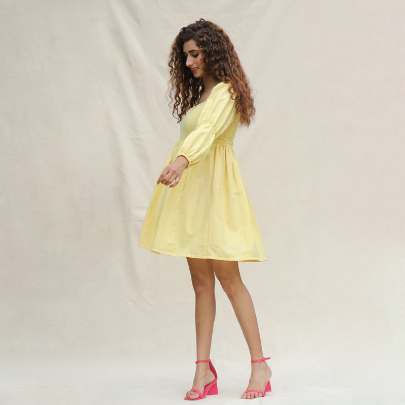 Left View of a Model wearing Light Yellow Handspun Cotton Bohemian Gathered Short Dress