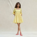 Front View of a Model wearing Light Yellow Handspun Cotton Bohemian Gathered Short Dress
