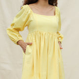 Front Detail of a Model wearing Light Yellow Handspun Cotton Bohemian Gathered Short Dress