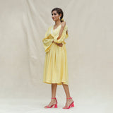 Left View of a Model wearing Light Yellow Handspun Cotton Bohemian Midi Dress