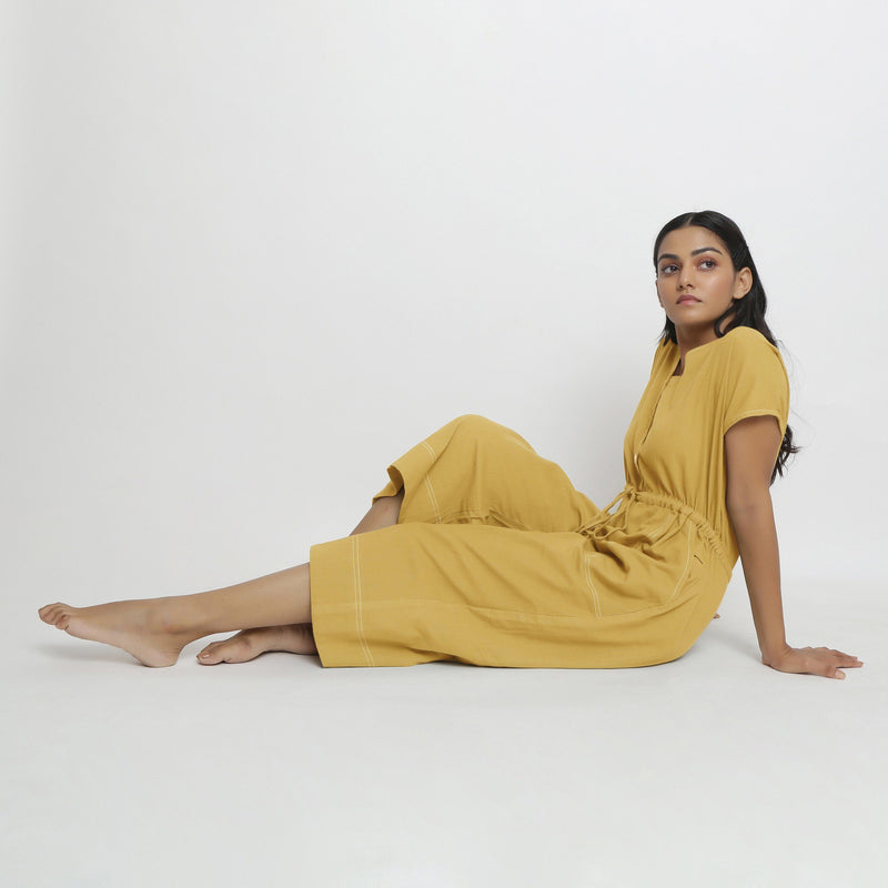 Left View of a Model wearing Light Yellow Vegetable Dyed Button-Down Jumpsuit