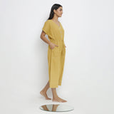 Right View of a Model wearing Light Yellow Vegetable Dyed Button-Down Jumpsuit