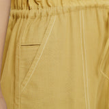 Close View of a Model wearing Light Yellow Vegetable Dyed Button-Down Jumpsuit