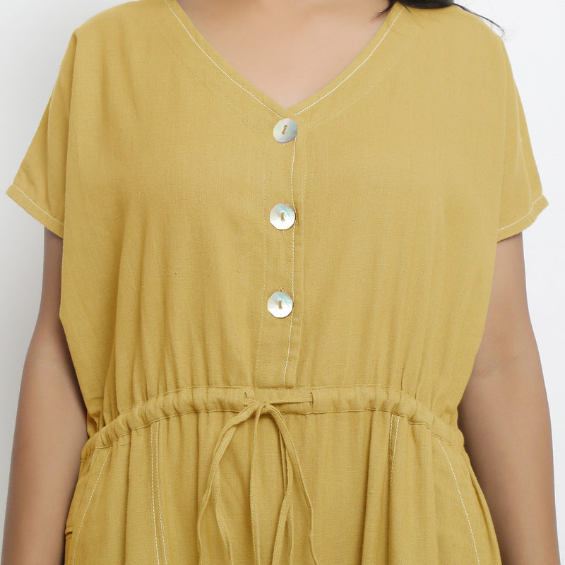 Front Detail of a Model wearing Light Yellow Vegetable Dyed Button-Down Jumpsuit