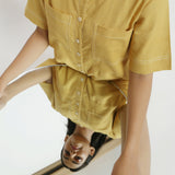 Front Detail of a Model wearing Light Yellow Vegetable Dyed Romper