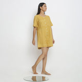Right View of a Model wearing Light Yellow Vegetable Dyed Romper