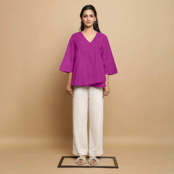 Front View of a Model wearing Magenta Embroidered Linen Asymmetrical Godet Top