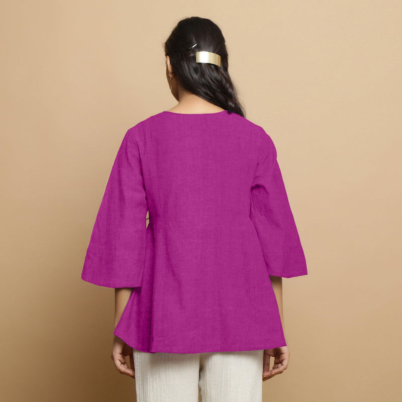 Back View of a Model wearing Magenta Embroidered Linen Asymmetrical Godet Top