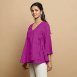 Left View of a Model wearing Magenta Embroidered Linen Asymmetrical Godet Top