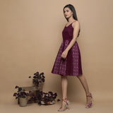 Left View of a Model wearing Maroon Ikat Handwoven Cotton Paneled Knee Length Dress