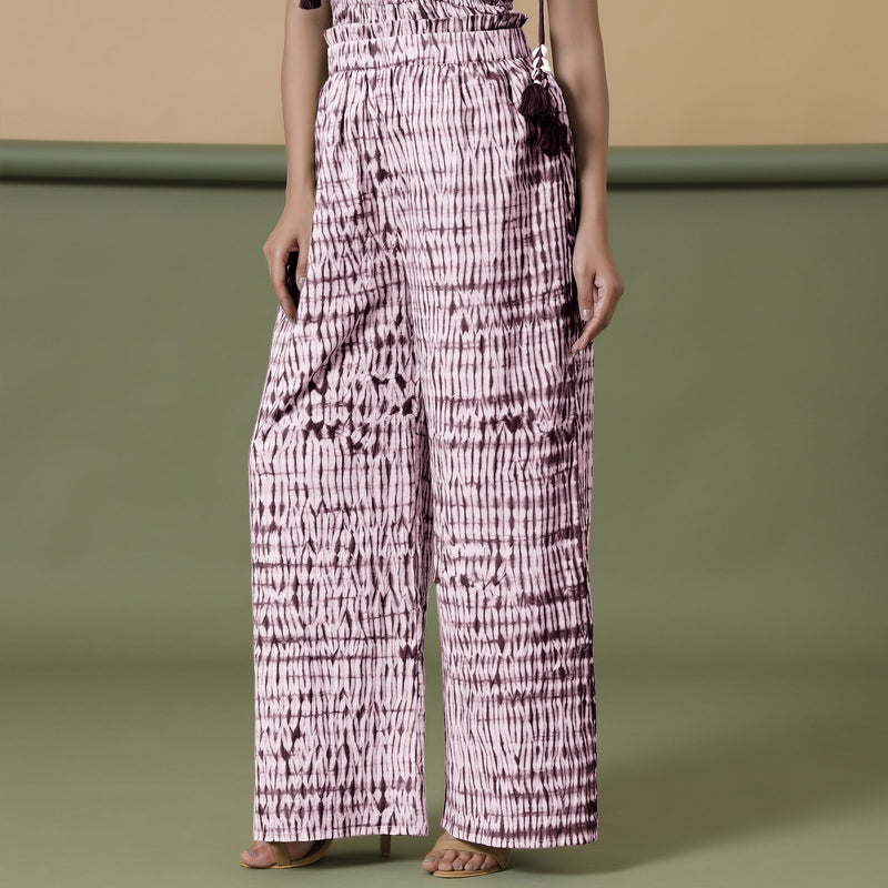 Left View of a Model wearing Maroon Shibori 100% Cotton Paperbag Pant