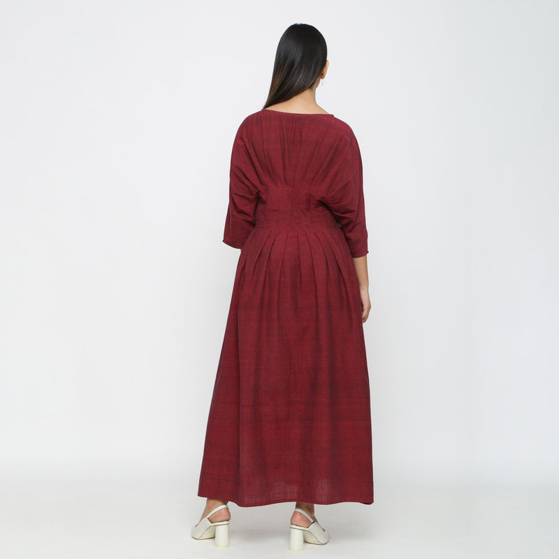 Back View of a Model wearing Maroon Solid Boat Neck Flared Dress
