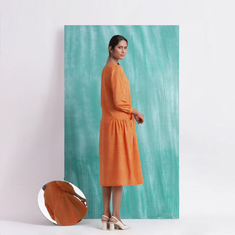 Back View of a Model wearing Melon Orange Comfort Fit Mirror Work Dress