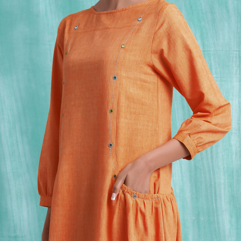 Front Detail of a Model wearing Melon Orange Comfort Fit Mirror Work Dress