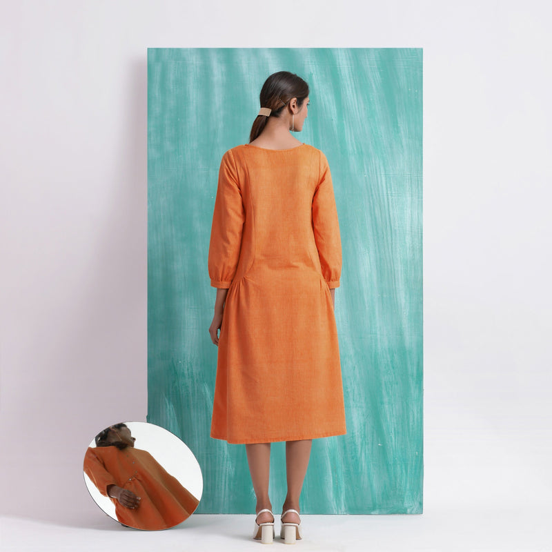 Back View of a Model wearing Melon Orange Comfort Fit Mirror Work Dress