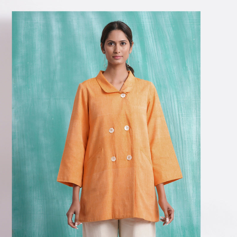Front View of a Model wearing Melon Orange Welt Pocket Handwoven Coat