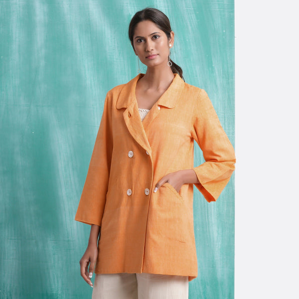 Front View of a Model wearing Melon Orange Welt Pocket Handwoven Coat