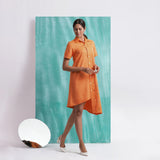 Right View of a Model wearing Melon Orange Mirrored Asymmetrical Shirt Dress