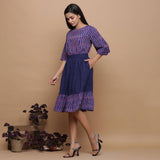 Left View of a Model wearing Midnight Blue Handwoven Ikat Top and Skirt Set