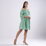Right View of a Model wearing Green Off-Shoulder Fit and Flare Dress