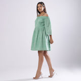 Left View of a Model wearing Green Off-Shoulder Fit and Flare Dress
